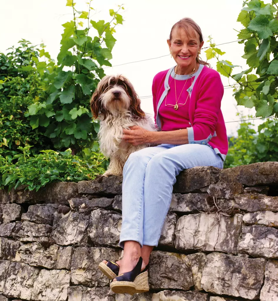 Lalou Bize-Leroy (and Basil) on the wall at the top of her parcel of the Grand Cru Richebourg vineyard. Vosne-Romane, Cte d'Or, France. [Cte de Nuits]